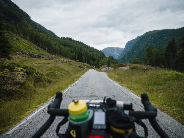Oh road.. view over bicycle handlebars and narrow tarmac road