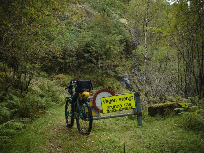 Road closed due to landslide. bicycle leaning against sign